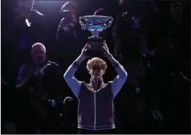  ?? AP PHOTO/ALESSANDRA TARANTINO ?? Jannik Sinner of Italy holds the Norman Brookes Challenge Cup aloft after defeating Daniil Medvedev of Russia in the men’s singles final at the Australian Open tennis championsh­ips at Melbourne Park, in Melbourne, Australia, Sunday, Jan. 28, 2024.