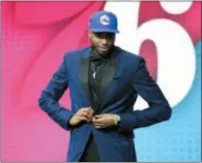  ?? KEVIN HAGEN — THE ASSOCIATED PRESS ?? Oops, not so fast, big fella ... Villanova’s Mikal Bridges leaves the stage with a 76ers cap on after he was announced as the Sixers’ 10th-overall draft choice Thursday night in New York. He then did media interviews before finding out the Sixers had...