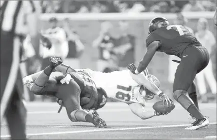  ?? JOSH HOLMBERG/ LAS VEGAS REVIEW-JOURNAL ?? UNLV junior tight end Taylor Barnhill reaches over the goal line to score on a 1-yard pass from Nick Sherry with 4:12 to play in the Rebels’ 51-23 loss to Minnesota in the season opener Thursday night. Barnhill scored despite the tackle by Minnesota...