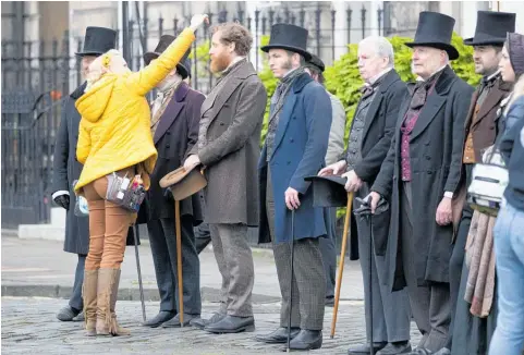  ??  ?? Left, film extras wait between scenes during filming in Edinburgh for Julian Fellowes' new period drama Belgravia.
Below, Julian Fellowes says the 1840s of his latest series is set was “one of the first periods of where the warning shots were fired across the bows of the old aristocrac­y”.