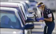  ?? CHARLIE RIEDEL / AP ?? Setting up drive-through polling locations, like this one in Kansas City, were one of themeans states used to ease voting in the pandemic.