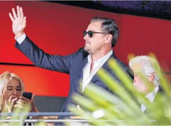  ?? FABRIZIO BENSCH/REUTERS ?? Cast member Leonardo Dicaprio waves as he arrives for the Berlin premiere of “Once Upon a Time in Hollywood,” in Berlin, Germany, earlier this month.