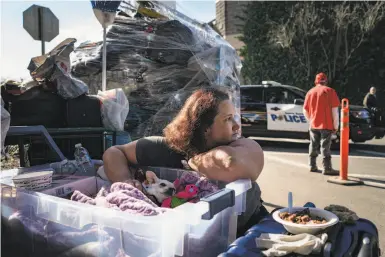  ?? Photos by Rachel Bujalski / Special to The Chronicle ?? Sandra Morton, 39, a cook at Denny’s, gathers her belongings after leaving her home on the Joe Rodota Trail.