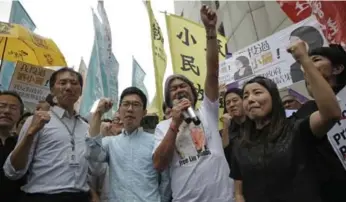  ?? KIN CHEUNG/THE ASSOCIATED PRESS ?? Edward Yiu, left, Nathan Law, Leung Kwok-hung and Lau Siu-lai protest their disqualifi­cation from office on Friday.