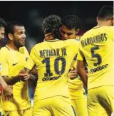  ??  ?? PSG’s Neymar, centre right back to camera, is congratula­ted by teammate Dani Alves after scoring his side’s 3rd goal Photo: AP