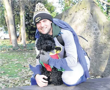  ??  ?? BATMAN and Robin — aka George Bruce and his trusty companion Strummer — arrived in Dundee at the end of a proper “superhero” walk.
George and Strummer, an 18-monthold cockapoo, had walked all the way from Tiree — more than 180 miles — to raise money...