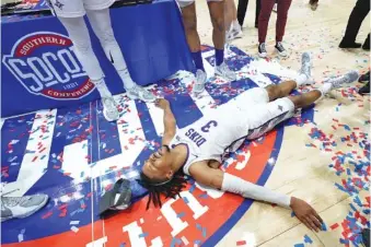  ?? AP PHOTO/KATHY KMONICEK ?? Furman guard Mike Bothwell celebrates his team’s win over UTC in the SoCon tournament title game on March 6 in Asheville, N.C.