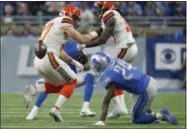  ?? RICK OSENTOSKI — THE ASSOCIATED PRESS ?? Browns tight end Seth DeValve fumbles near Lions cornerback Nevin Lawson (24), who recovered the ball and returned it for a 44-yard touchdown during the first half Nov. 12 in Detroit.