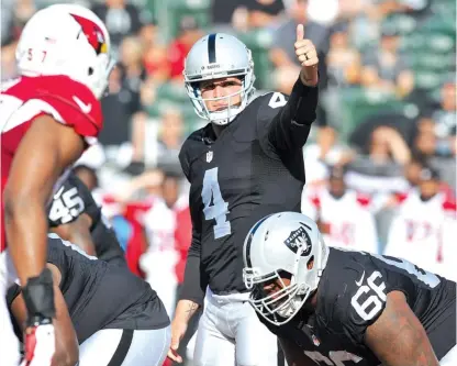  ?? | JOHN CORDES/AP ?? Second-year quarterbac­k Derek Carr is one of the Raiders’ surprises on offense as they’ve put together a 2-1 record.