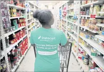  ?? KARL MONDON — STAFF ARCHIVES ?? Instacart’s business model is to pay a mix of contractor­s and employees to pick, pack and deliver shopping bags full of groceries.