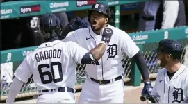  ?? CARLOS OSORIO — THE ASSOCIATED PRESS ?? Detroit Tigers’ Akil Baddoo, left, is greeted by Jeimer Candelario after hitting a solo home run in his first Major League at-bat Sunday.