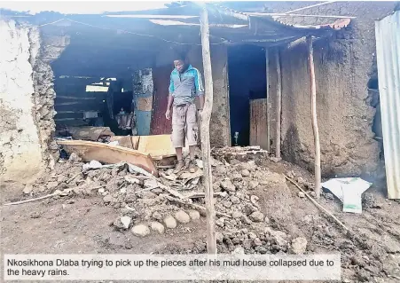  ?? ?? Nkosikhona Dlaba trying to pick up the pieces after his mud house collapsed due to the heavy rains.