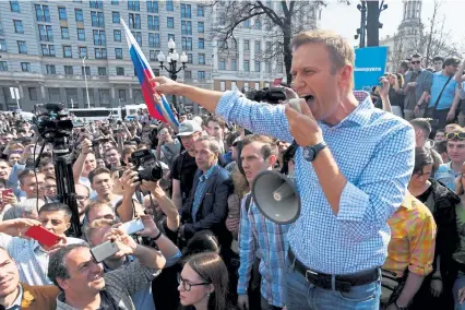  ?? Kirill Kudryavtse­v, AFP/Getty Images file ?? Russian opposition leader Alexei Navalny addresses supporters during an unauthoriz­ed anti-Putin rally in Moscow in 2018.