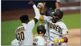  ?? (AP/Gregory Bull) ?? San Diego’s Fernando Tatis Jr. (right) celebrates with Jurickson Profar on Thursday after Tatis hit a two-run home run during the seventh inning of the Padres’ 11-9 victory over the St. Louis Cardinals at Petco Park in San Diego.