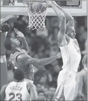  ?? MICHAEL DWYER — ASSOCIATED PRESS ?? Andre Iguodala dunks without looking in front of the Celtics’ Marcus Smart in the Warriors’ 92-88loss.