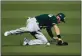  ?? KEVORK DJANSEZIAN — GETTY IMAGES ?? The Oakland A’s Robbie Grossman misses the catch on a ball hit by the Houston Astros’ Josh Reddick during the fourth inning in Game 4 of the American League Division Series on Thursday in Los Angeles.