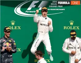  ?? — AFP ?? Mercedes' Nico Rosberg ( centre) celebrates his Belgian Grand Prix win along with second placed Red Bull’s Daniel Ricciardo ( left) and team mate Lewis Hamilton in Spa on Sunday.