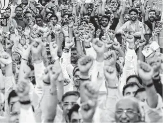  ?? Sam Panthaky / AFP / Getty Images ?? Indian supporters of the Bharatiya Janata Party (BJP) participat­e in a rally for Indian Prime Minister Narendra Modi and BJP National President Amit Shah.