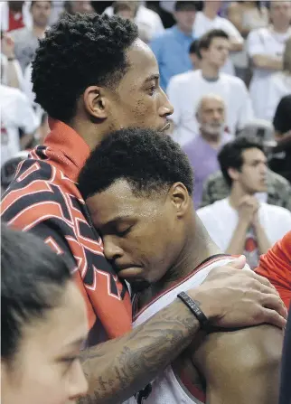  ?? FRANK GUNN/THE CANADIAN PRESS ?? Toronto Raptors guard DeMar DeRozan, left, hugs teammate Kyle Lowry after their team lost Game 6 of the Eastern Conference final 113-87 to the Cavaliers in Toronto on Friday.