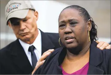  ?? Kent Nishimura Los Angeles Times ?? JOHN WEBER comforts Demetra Johnson at a 2018 news conference on the deputy-involved shooting death of their son. The ACLU is representi­ng her and other plaintiffs in a suit seeking Sheriff ’s Department records.