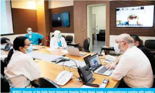  ??  ?? BEIRUT: Director of the Rafiq Hariri University Hospital Firass Abiad, heads a videoconfe­rence meeting with medics inside the coronaviru­s department in the capital Beirut. — AFP