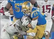  ?? Ashley Landis Associated Press ?? ZACH CHARBONNET (24), rushing against Stanford, transferre­d to UCLA from Michigan.