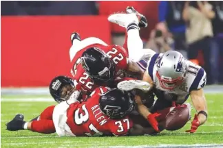  ?? ASSOCIATED PRESS FILE PHOTOS ?? The New England Patriots’ Julian Edelman (11) makes a catch as the Atlanta Falcons’ Ricardo Allen and Keanu Neal defend during the second half of Super Bowl LI in Houston on Feb. 5. Down by eight points with about two minutes left, the Patriots needed...