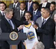  ?? AP PHOTO BY PABLO MARTINEZ MONSIVAIS ?? Golden State Warriors head basketball coach Steve Kerr presents President Barack Obama with a Golden State Warriors team basketball jersey during a ceremony in the East Room of the White House in Washington, Thursday where the president honored the 2015 NBA Champions.