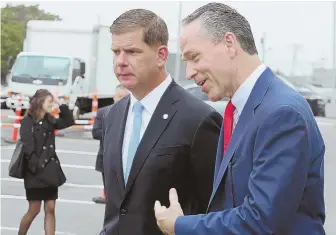  ?? STAFF PHOTO BY ANGELA ROWLINGS ?? AUGMENTED REALITY? Mayor Martin J. Walsh is seen at yesterday’s groundbrea­king of Suffolk Constructi­on’s new Roxbury headquarte­rs with Suffolk CEO John Fish.