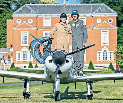  ?? ?? Zara and Mark Rutherford – youngest ever winners of the prestigiou­s Segrave Trophy – pose with their Shark plane at the Epsom golf course in Surrey