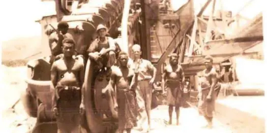  ??  ?? The great escape ... Tom Phelps and the miners in front of a dredge at Edie Creek (above); the men making their escape on a raft in 1942 (opposite page above); Tom Phelps with friend Una Beel before they fled the Japanese.