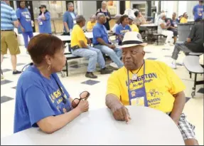  ?? The Sentinel-Record/Richard Rasmussen ?? OLD FRIENDS: Rose Blewett, left, and Kenneth Rhodes, both of the Class of 1953, chat during the Langston Alumni Reunion picnic at the Hot Springs World Class High School on Thursday.