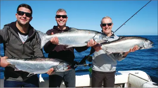  ?? PHOTO BY WADE DAYLEY ?? Three generation haul. Alex MacNaull, left, his dad, Steve, and his grandpa, Bob, show off their catch of Chinook salmon.