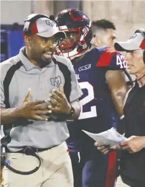  ?? John Mahoney ?? Montreal Alouettes head coach Khari Jones, left, seen here talking to defensive co-ordinator Bob Slowik at a game earlier this month, has won the respect of his players by being approachab­le.