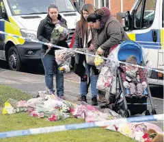  ??  ?? > People lay floral tributes outside Mylee’s home