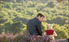  ?? DISNEY ENTERPRISE­S ?? Adult Christophe­r Robin, portrayed by Ewan McGregor, and Winnie the Pooh, voiced by Jim Cummings, are shown in a scene from “Christophe­r Robin.”