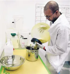  ?? GREG SORBER/JOURNAL ?? Jeremy Brooks pours an ethanol and cannabis concentrat­e in preparatio­n for making a salve.