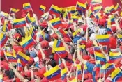  ?? ARIANA CUBILLOS/AP ?? Supporters of President Nicolas Maduro wave Venezuelan flags during a rally in Caracas, Venezuela on Saturday.