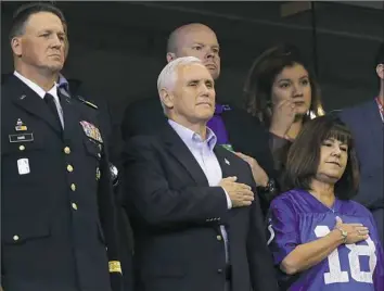  ??  ?? Vice President Mike Pence, front center, stands Sunday during the playing of the national anthem before an NFL game between the Indianapol­is Colts and the San Francisco 49ers in Indianapol­is.