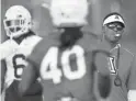  ?? KELLY PRESNELL/ARIZONA DAILY STAR ?? Coach Kevin Sumlin watches his Wildcats run through practice for the University of Arizona.