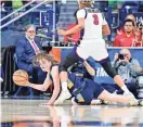  ?? MATT CASHORE/USA TODAY SPORTS ?? Marquette guard Mackenzie Hottinger passes the ball as Ole Miss guard Kennedy Todd-Williams defends during Saturday’s game.