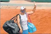  ??  ?? Ashleigh Barty waves goodbye as she retires with an injury during her match against Magda Linette.