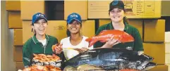  ??  ?? HIGH DEMAND: Great Barrier Reef Tuna employees Cynthia Matute, Khin Khin Soe and Sarah Lamason with seafood products.