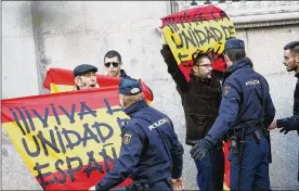  ?? FRANCISCO SECO / ASSOCIATED PRESS ?? Right-wingers protest Thursday with Spanish flags reading “Long live a united Spain” at the Supreme Court in Madrid. Six Catalan lawmakers testified before a judge over claims they ignored court orders and allowed an independen­ce vote.
