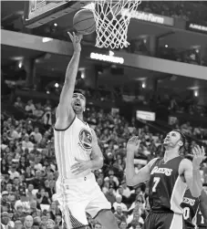  ?? SUSAN TRIPP POLLARD/STAFF ?? Golden State’s Zaza Pachulia takes a shot over the Lakers’ Larry Nance Jr.