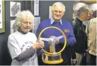  ??  ?? Brenda Jones of Bourne Heritage centre receives the Graham Hill Trophy from the Owen Motoring club’s roger Tolley.