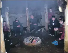  ??  ?? Pupils learn about how their ancestors lived in the recreated roundhouse at Brodick Castle.