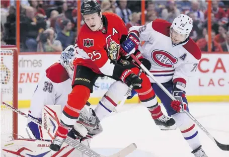  ?? WAYNE CUDDINGTON/OTTAWA CITIZEN ?? Montreal Canadiens defender Andrei Markov, right, tries to clear Ottawa’s Chris Neil from in front of Canadiens goalie Peter Budaj moments before Neil would assist in the Senators’ fifth goal of the game at Scotiabank Place on Wednesday.