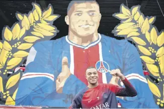  ?? FRANCK FIFE/AGENCE FRANCE-PRESSE ?? KYLIAN Mbappe poses in front of a giant tifo ahead of the PSG and Toulouse match at the Parc des Princes Stadium in Paris.