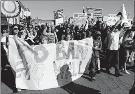  ?? ASSOCIATED PRESS ?? PROTESTERS MARCH DURING a May Day demonstrat­ion Monday in Oakland, Calif. Immigrant and union groups marched in cities across the United States on Monday, to mark May Day and protest against President Donald Trump’s efforts to boost deportatio­ns.